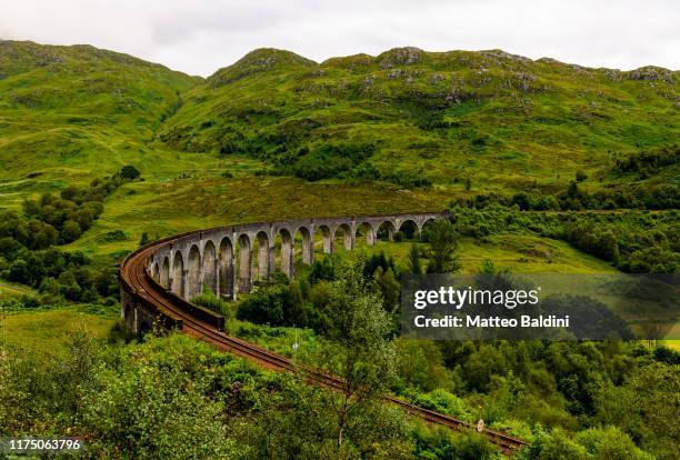 aerial picture taken by the drone above the glenfinnan viaduct, the famous viaduct that bring harry potter to hogwarts - glenfinnan stock pictures, royalty-free photos & images