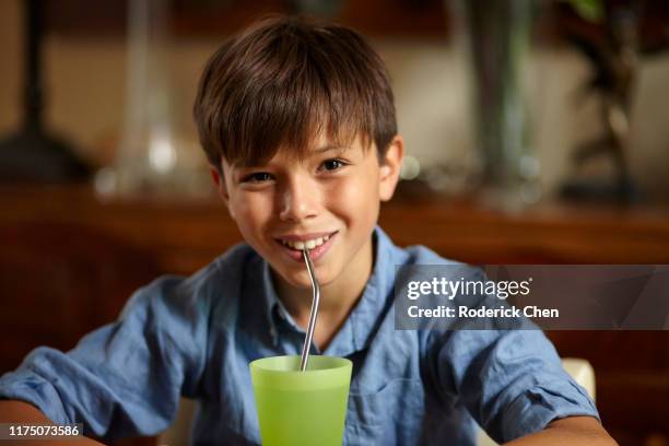 young boy with an ecological drinking straw - kitchen utensil stock pictures, royalty-free photos & images