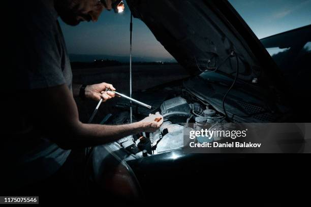 car repair. lucky me. fixing the car in the middle of nowhere at dusk. diy - roadside challenge stock pictures, royalty-free photos & images