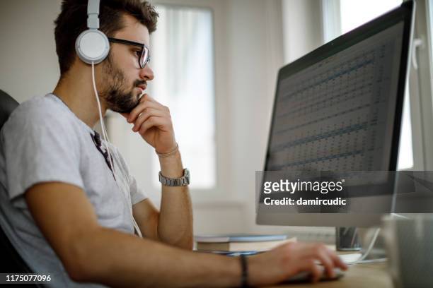 young man studying at home - students working on pc school stock pictures, royalty-free photos & images