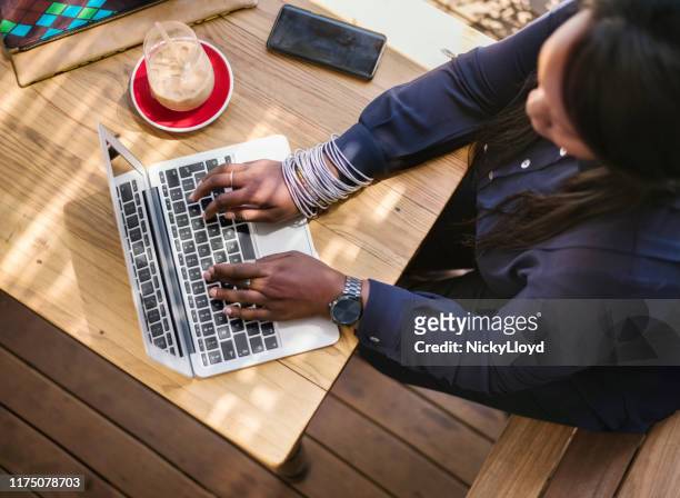 schnelle antwort an den kunden - african creative with laptop working outside stock-fotos und bilder