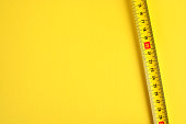 Tape measure scale on a yellow background. Copy space.