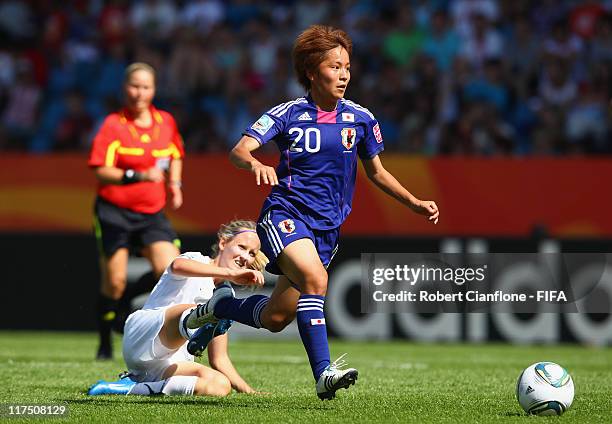 Mana Iwabuchi of Japan is challenged by Katie Hoyle of New Zealand during the FIFA Women's World Cup 2011 Group B match between Japan and New Zealand...