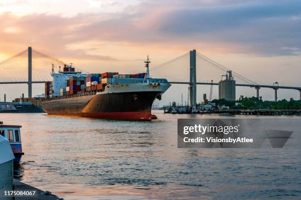 dusk falls over the last container ship loaded for today, ready to head down the savannah river t the atlantic ocean - savannah georgia stock pictures, royalty-free photos & images