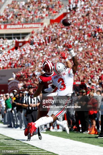 Damon Arnette of the Ohio State Buckeyes and Peyton Hendershot of the Indiana Hoosiers jump for the ball at Memorial Stadium on September 14, 2019 in...