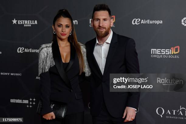 Barcelona's Argentine forward Lionel Messi and his wife Antonella Roccuzzo pose on the red carpet during the premiere of Cirque du Soleil's latest...