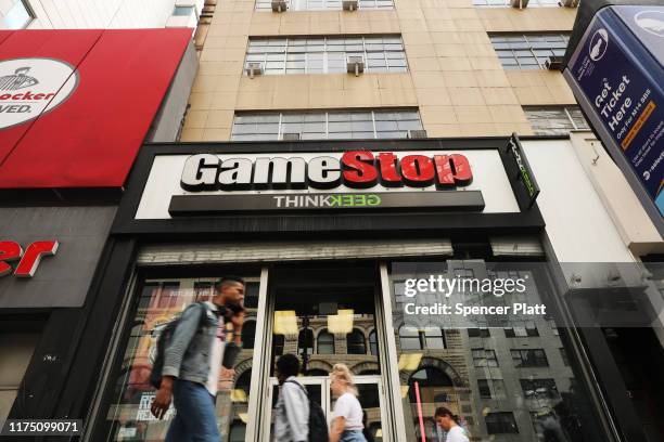 People pass a GameStop store in lower Manhattan on September 16, 2019 in New York City. GameStop has announced that they will be closing between 180...
