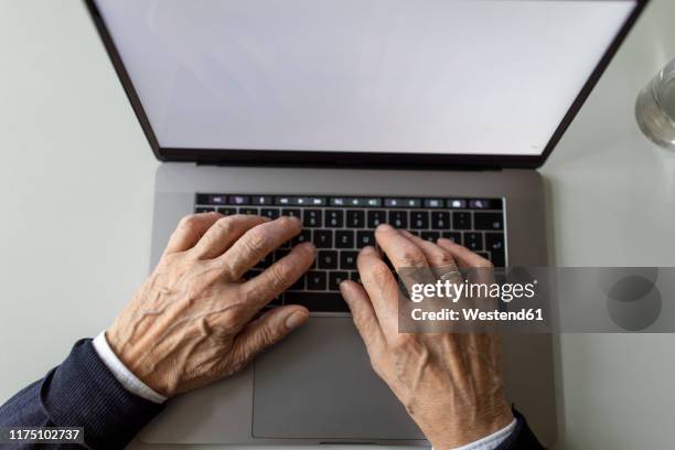 close-up of senior man using laptop - old monitor computer stock-fotos und bilder