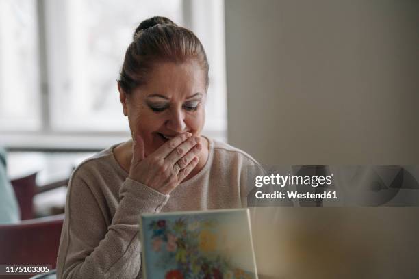 happy senior woman looking in jewelry box at home - memories box stock pictures, royalty-free photos & images