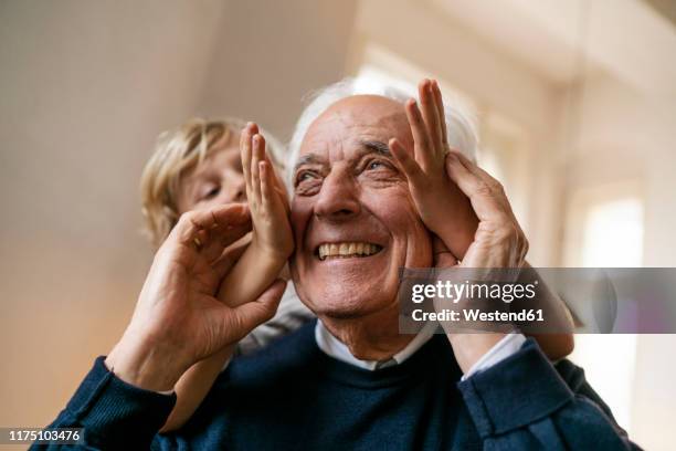 playful grandson with grandfather at home - carefree kids stock pictures, royalty-free photos & images