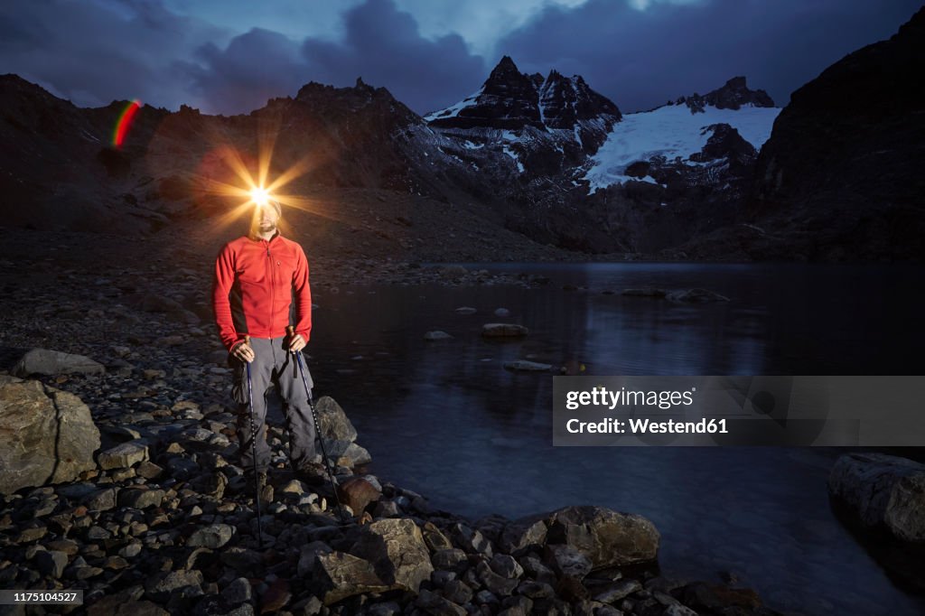 Hiker with headlamp standing at Lago de los Tres, Los Glaciares National Park, Patagonia, Argentina
