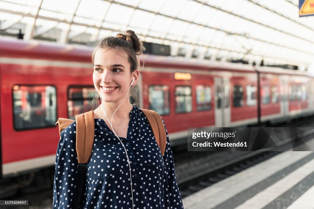 Portrait of smiling young woman at the train station