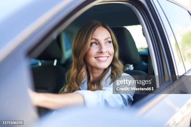 woman in a car - woman driving stock pictures, royalty-free photos & images