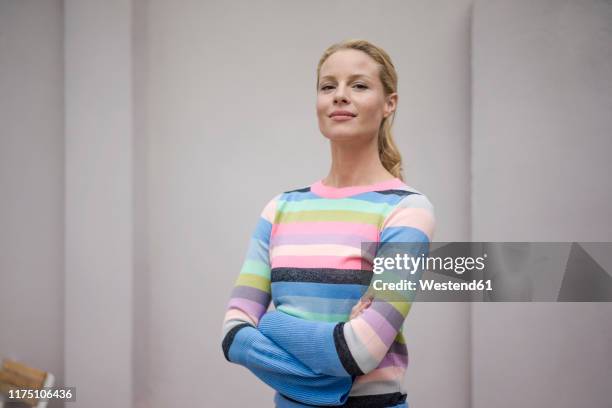 portrait of beautiful blond woman, wearing striped pullover - proud woman stock-fotos und bilder