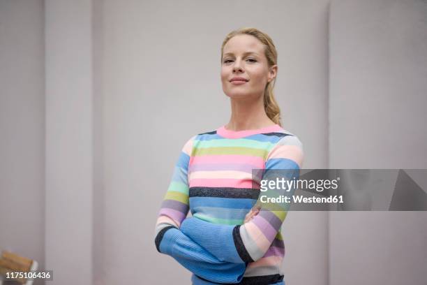 portrait of beautiful blond woman, wearing striped pullover - orgoglio foto e immagini stock