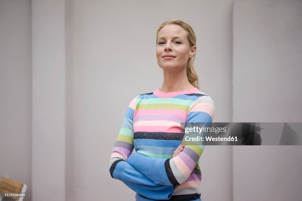 Portrait of beautiful blond woman, wearing striped pullover