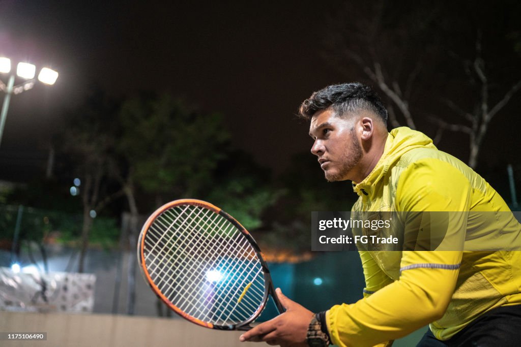 Side view of a tennis player ready to play