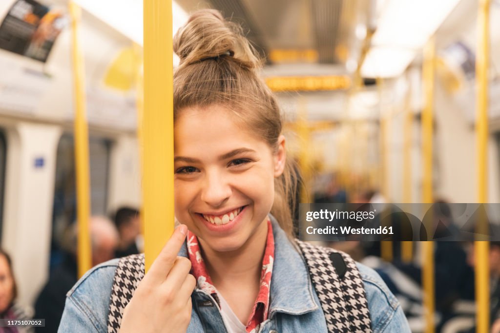 Portrait of smiling young woman in the metro