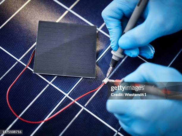 technician measuring resistor of silicon solar cell - silicon stock pictures, royalty-free photos & images