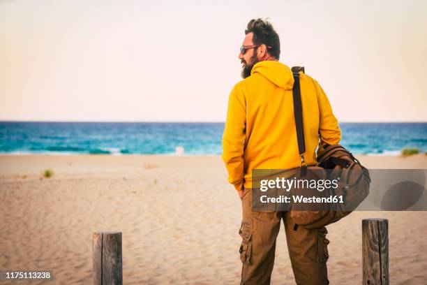 man with yellow hoodie sweater and brown basket - man and his hoodie imagens e fotografias de stock