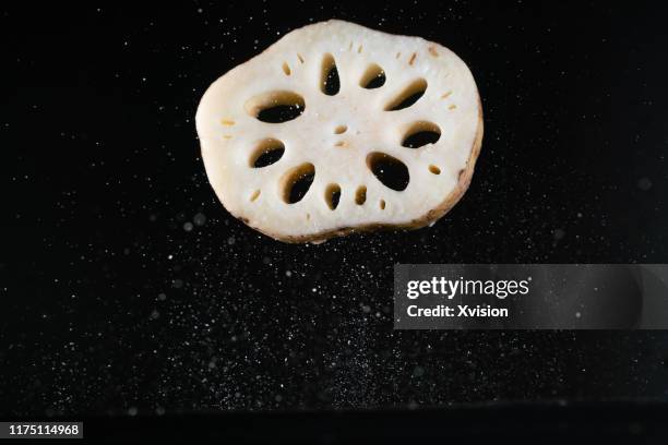 lotus root flying in mid air captured with high speed sync. - lotusrot bildbanksfoton och bilder