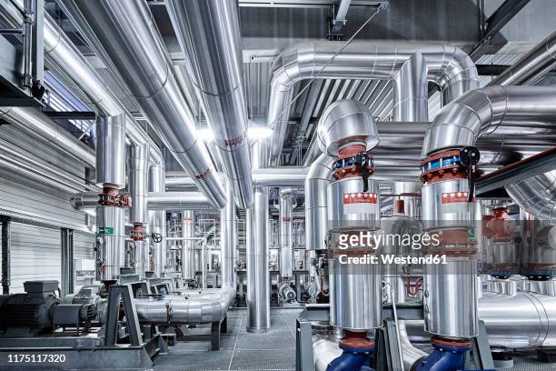 pipeworks with insulation in a technical room - herstellendes gewerbe stock-fotos und bilder