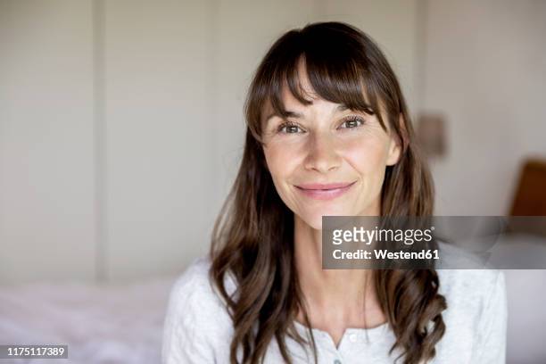 portrait of smiling woman at home - brown hair stock pictures, royalty-free photos & images