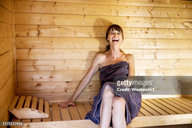 portrait of laughing woman in a sauna - hälsosalong bildbanksfoton och bilder