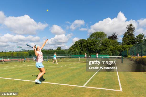 mature women during a tennis match on grass court - tennis game stock pictures, royalty-free photos & images