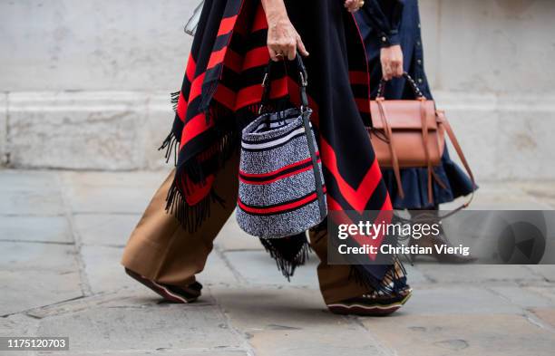 Guest is seen wearing striped bag outside Erdem during London Fashion Week September 2019 on September 16, 2019 in London, England.