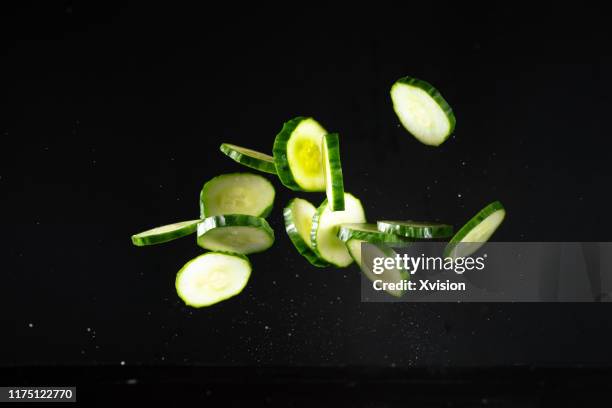 cutted cucumber flying in mid air captured with high speed sync."n - food mid air stock pictures, royalty-free photos & images