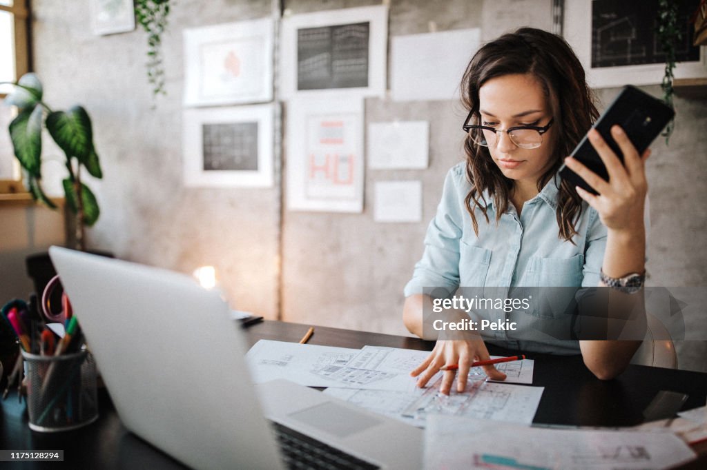 Multitasking of young female entrepreneur at work