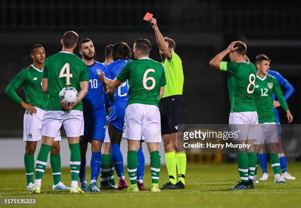 Moise Kean of Italy receives a red card from referee Sascha Stegemann during the UEFA U21 Championships Qualifier match between the Republic of...
