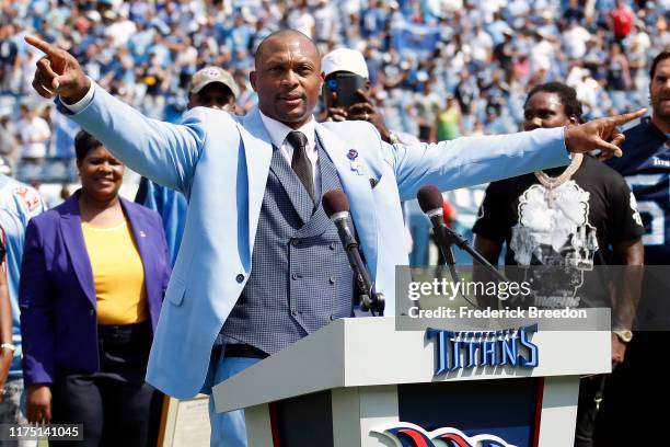 Former running back of the Tennessee Titans speaks to the crowd during a half time presentation to retire his jersey number and that of teammate...