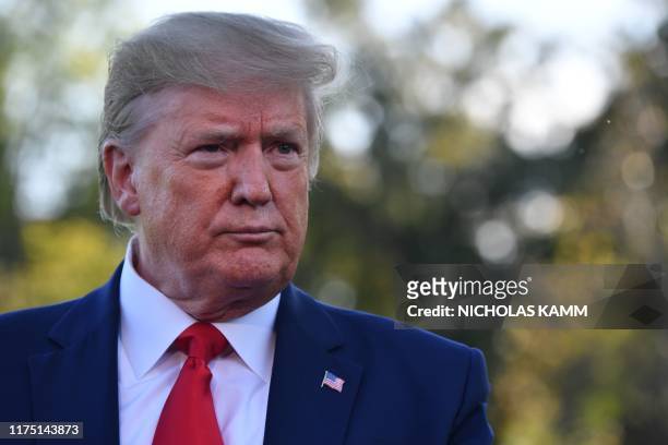 President Donald Trump looks on as he speaks to the media prior to departing from the South Lawn of the White House in Washington, DC on October 10,...
