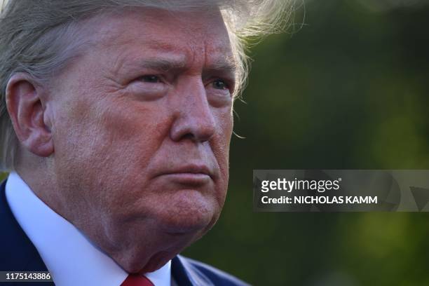 President Donald Trump looks on as he speaks to the media prior to departing from the South Lawn of the White House in Washington, DC on October 10,...
