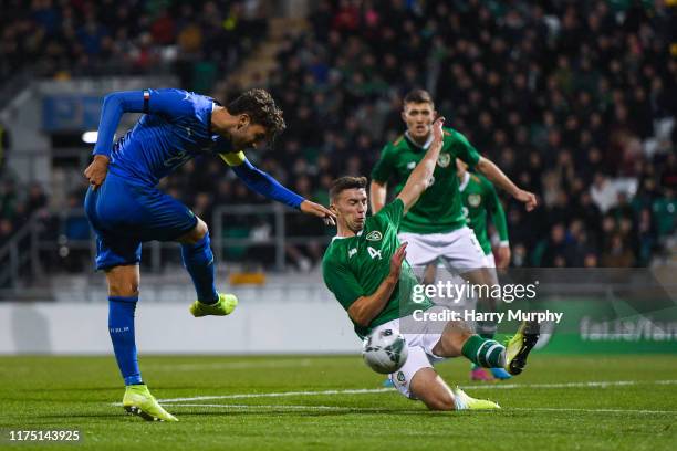 Manuel Locatelli of Italy has a shot blocked by Conor Masterson of Republic of Ireland during the UEFA U21 Championships Qualifier match between the...