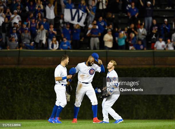 Albert Almora Jr. #5, Jason Heyward and Ian Happ of the Chicago Cubs celebrate the 8-2 victory against the Cincinnati Reds at Wrigley Field on...