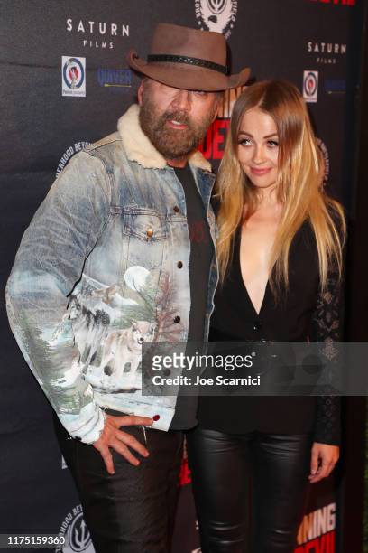 Nicolas Cage and Erika Koike arrive at the Premiere of Quiver Distribution's "Running With The Devil" at Writers Guild Theater on September 16, 2019...