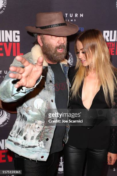 Nicolas Cage and Erika Koike arrive at the Premiere of Quiver Distribution's "Running With The Devil" at Writers Guild Theater on September 16, 2019...