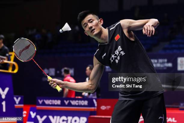 Chen Long of China hits the shuttlecock into the crowd after the Men's Singles first round match against Lee Zii Jia of Malaysia on day one of the...