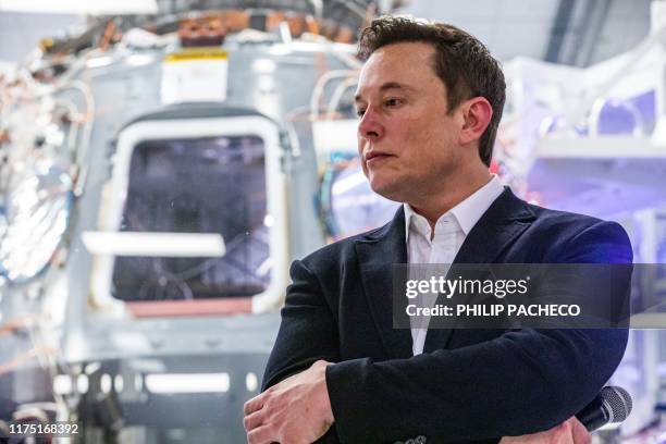 SpaceX founder Elon Musk addresses members of the media during a press conference announcing new developments of the Crew Dragon reusable spacecraft,...