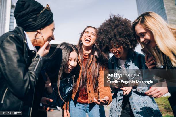friends laughing in street, milan, italy - five people stock-fotos und bilder