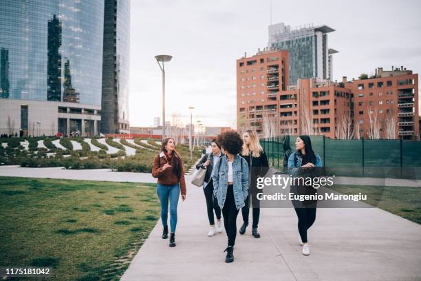 friends walking in street, milan, italy - milan city stock pictures, royalty-free photos & images