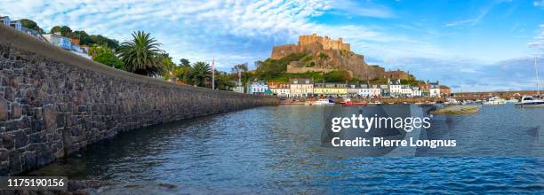 the harbour of gorey and gorey castle  (also known as mont orgueil castle) in backdrop - channel islands england stock pictures, royalty-free photos & images