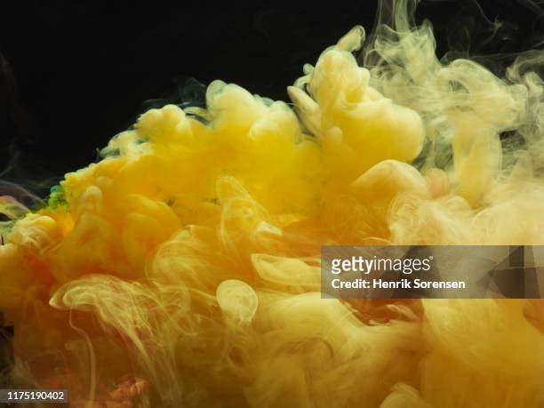 colored smoke - yellow smoke stock pictures, royalty-free photos & images