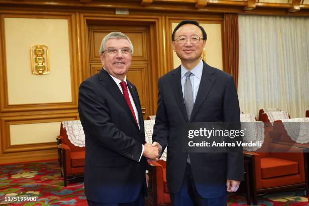 Chinese State Councilor Yang Jiechi shakes hands with President of the International Olympic Committee Thomas Bach at Zhongnanhai on September 17,...