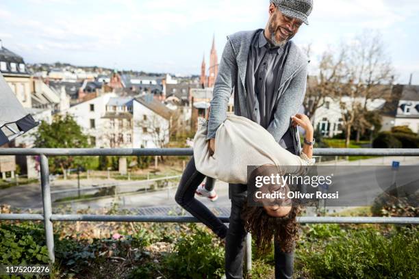 playful father and daughter in the city - rheingau stockfoto's en -beelden