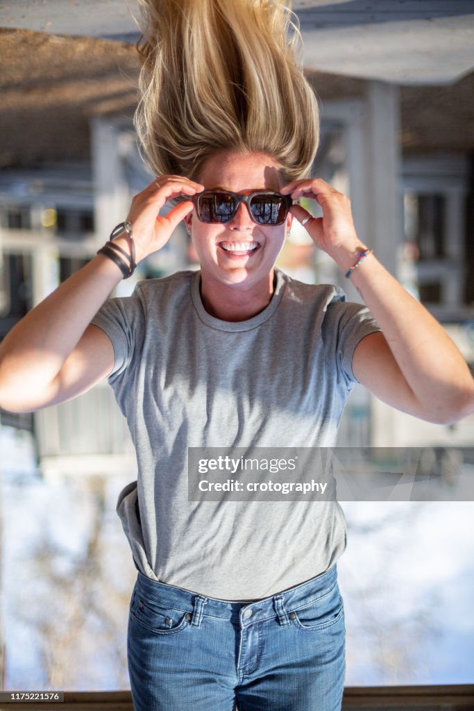 Smiling Woman hanging upside down in a playground, United States