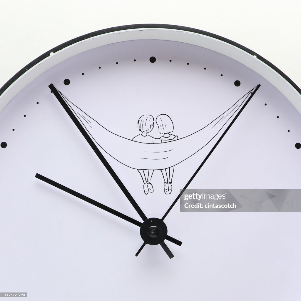 Conceptual couple sitting in a hammock